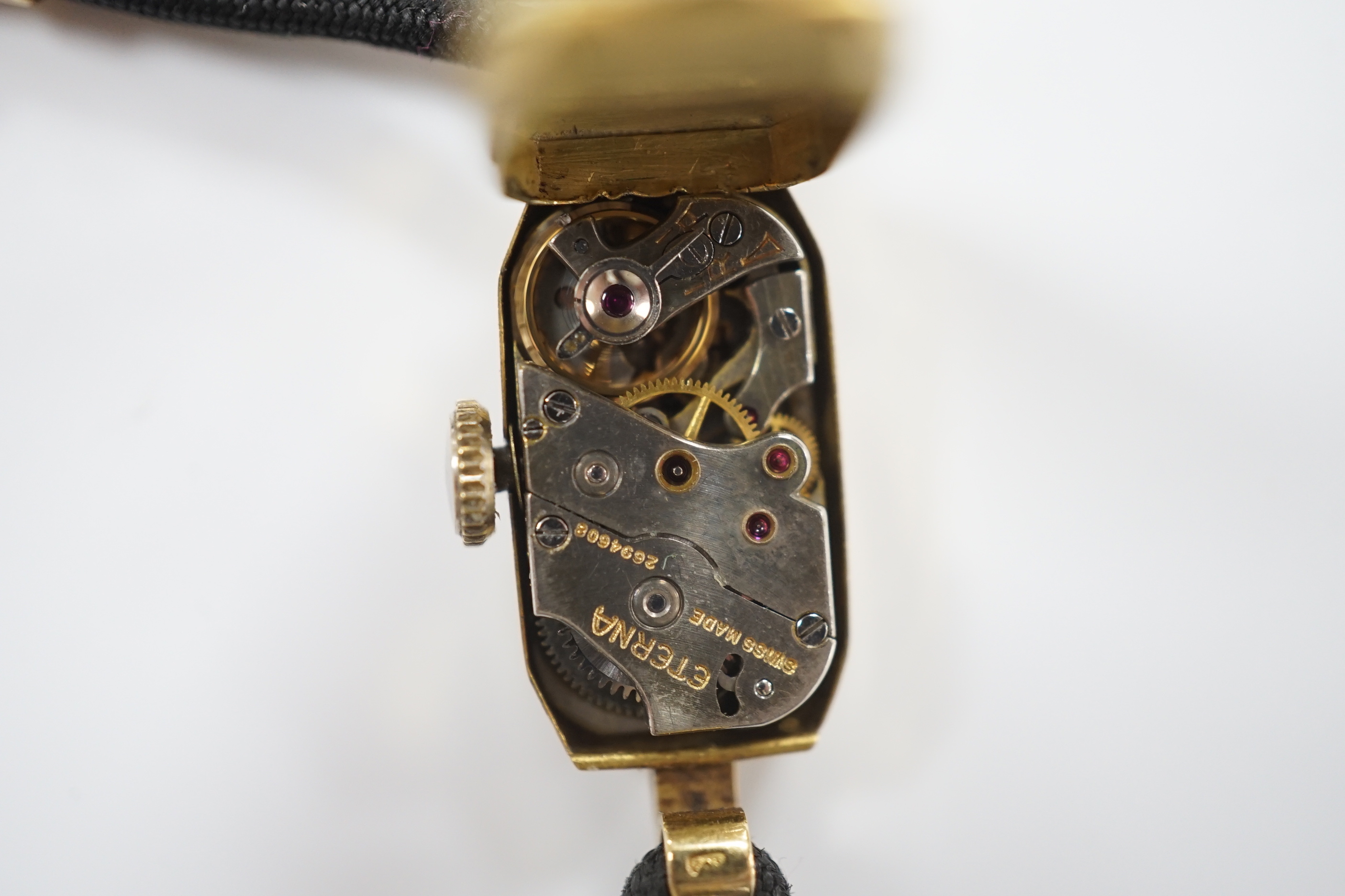 A lady's 1930's 18ct gold Eterna manual wind wrist watch, on a twin strand fabric strap with gold plated clasp